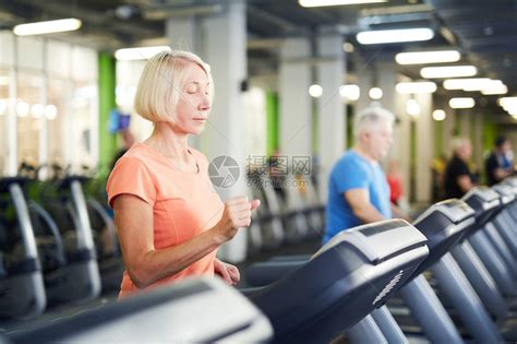 在当代体育中心或健身场的一部运动机上参加活跃服装锻炼的高清图片下载-正版图片505873263-摄图网