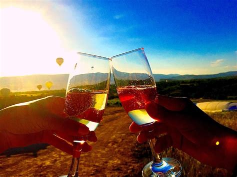 Premium Photo | Cropped hands toasting champagne flutes during sunny day