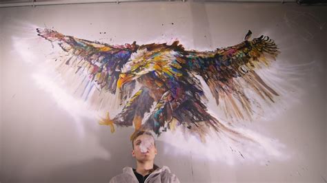 Premium Photo | Artist designer draws an eagle on the wall craftsman ...