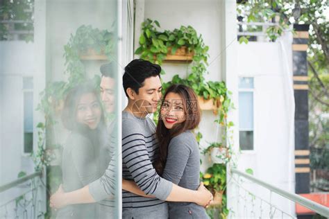 相爱的夫妇家里的阳台上拥抱,分享情感幸福高清图片下载-正版图片300105620-摄图网