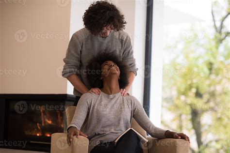 multiethnic couple hugging in front of fireplace 10389656 Stock Photo ...