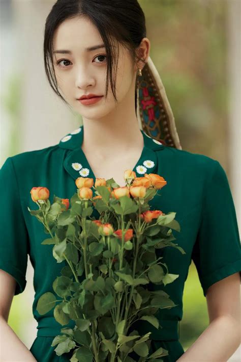 周洁琼身穿墨绿长裙手持鲜花，恰似知性温柔的公主，优雅迷人！