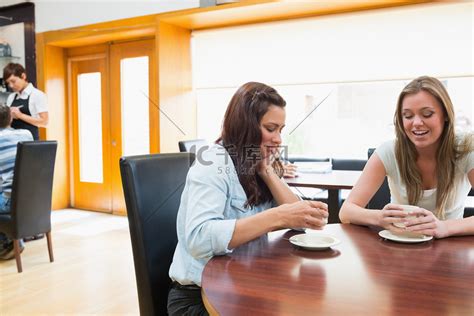 两个女人坐在自助餐厅喝咖啡高清摄影大图-千库网