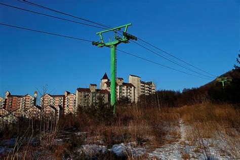Empty buildings are seen at the abandoned Alps Ski Resort #19902708