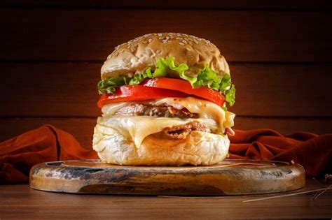 Premium Photo | Delicious hamburger on wooden table spices and brown fabric