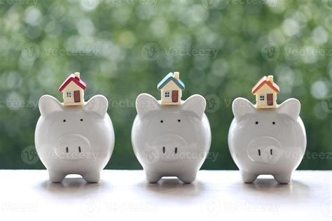 Piggy banks with model houses on a natural green background 2160139 ...