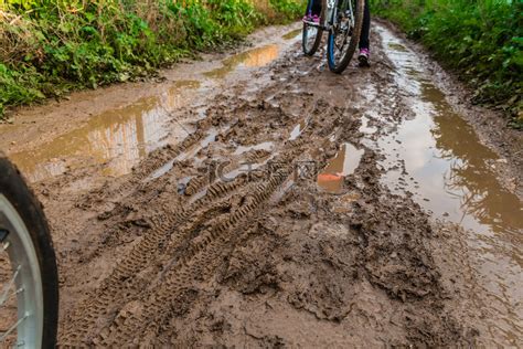 骑自行车穿过泥泞的土路高清摄影大图-千库网