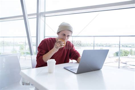 这位年轻的自由职业者坐在咖啡馆里高清图片下载-正版图片502849648-摄图网