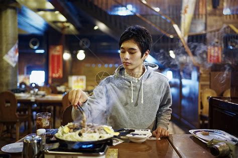 餐馆里独自吃饭的青年男性高清图片下载-正版图片502102585-摄图网