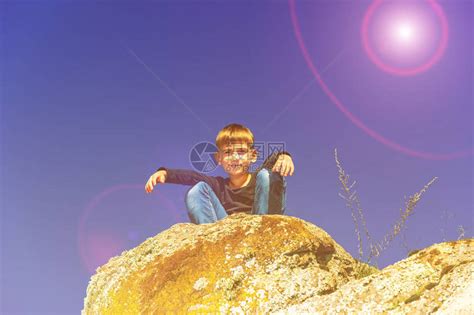 男孩蹲在悬崖顶上往下看高清图片下载-正版图片504575238-摄图网