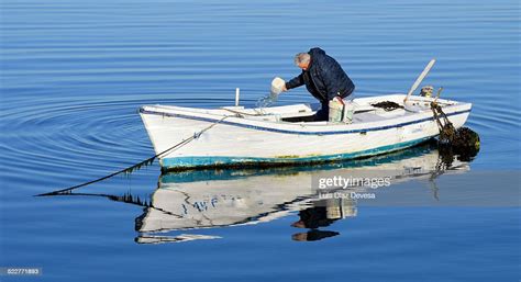 Fisherman Bailing Out Boat High-Res Stock Photo - Getty Images