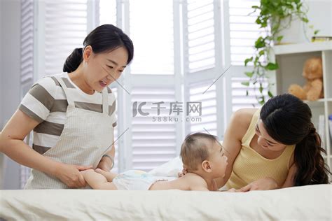 保姆和年轻妈妈一起照顾宝宝高清摄影大图-千库网