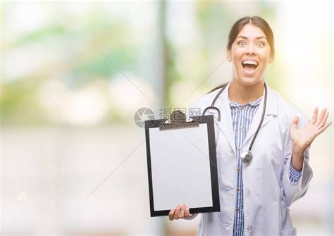 年轻美丽的印度女医生拿着剪贴板同时高清图片下载-正版图片504137243-摄图网