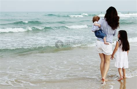 母亲带着两个女儿在沙滩上高清图片下载-正版图片502521009-摄图网