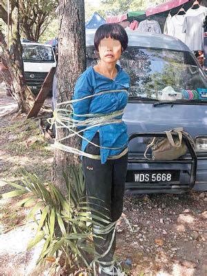 港媒:内地女子马来西亚行骗 被居民围捕绑树上|行骗|马来西亚_新浪新闻