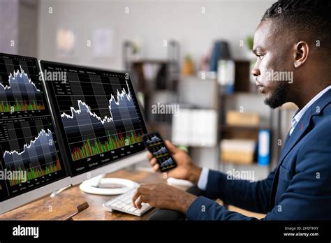 Stock Market Analyst At Office Desk Using Multiple Screens Stock Photo ...