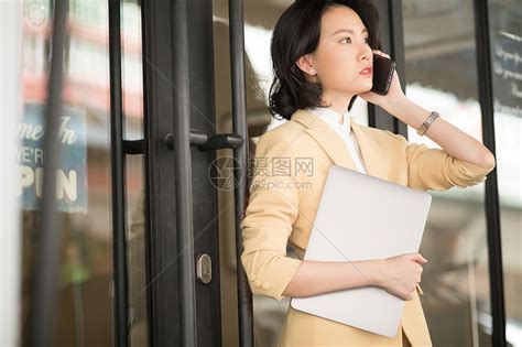 商务女性抱着笔记本电脑打电话高清图片下载-正版图片502334285-摄图网