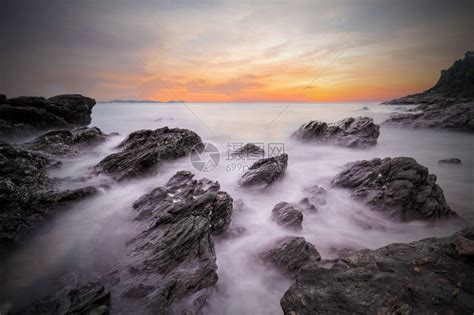 云海洋雅日落时温柔的海浪黑暗沙滩前方有石块泰国乔莱姆亚武科萨迈特公园Rayong海景长照射拍摄高清图片下载-正版图片308071580-摄图网