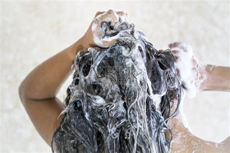 年轻女子在淋浴时用泡沫去屑洗发水洗头。照片摄影图片_ID:428018274-Veer图库