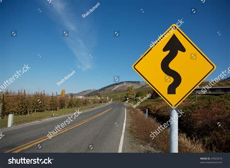 Winding Yellow Traffic Sign Against Winding Road Stock Photo 47023519 ...