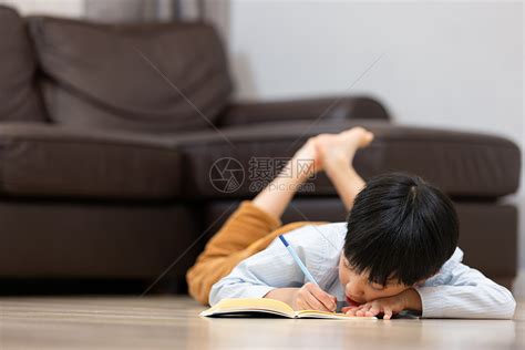 趴在地上写作业的小男孩高清图片下载-正版图片501724246-摄图网