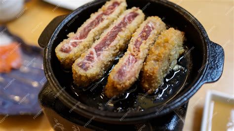 Premium Photo | Gyukatsu or gyu katsu is a crispy deep fried rare beef ...