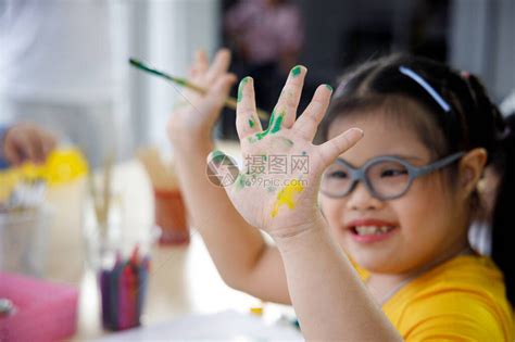 带着唐氏综合症的亚洲快乐女孩在艺术课上用高清图片下载-正版图片503945479-摄图网