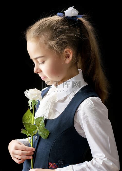 小女孩手里拿着一朵花。高清摄影大图-千库网