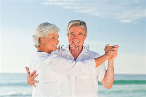 在海滩上跳舞的成熟夫妇高清摄影大图-千库网